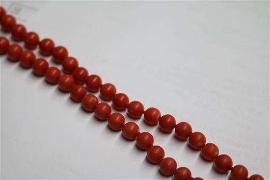 A single strand graduated coral bead necklace, with yellow metal clasp, gross weight 53 grams, 64cm.